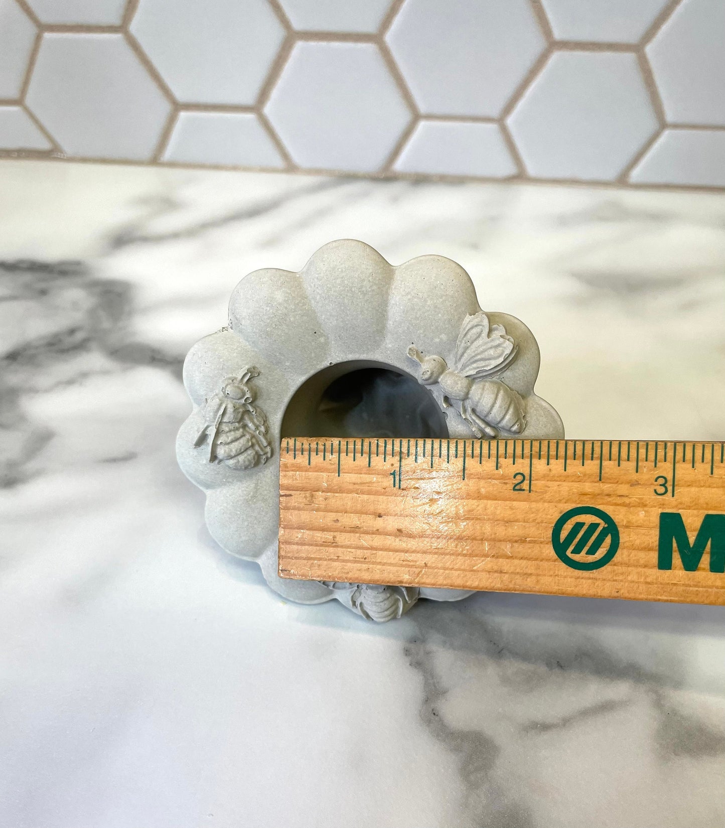 Concrete taper holder designed with honeybees